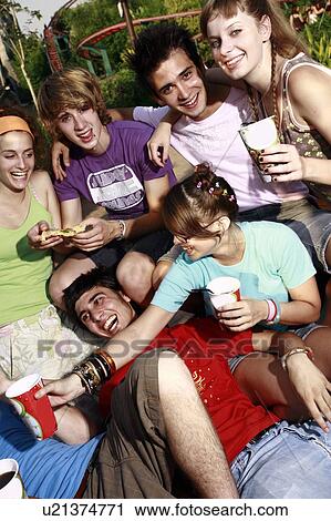 Stock Image - Teenagers hanging out, eating. Fotosearch