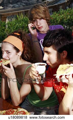 Teenagers hanging out, eating View Large Photo Image Stock Photo - Teenagers hanging out, eating. Fotosearch