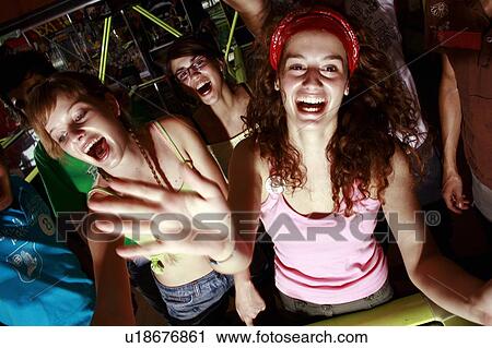 Teenagers playing game in arcade View Large Photo Image Stock Image - Teenagers playing game in arcade. Fotosearch