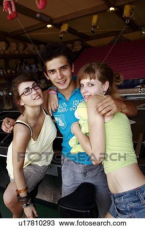 Stock Image - Teenagers posing at game in arcade. Fotosearch