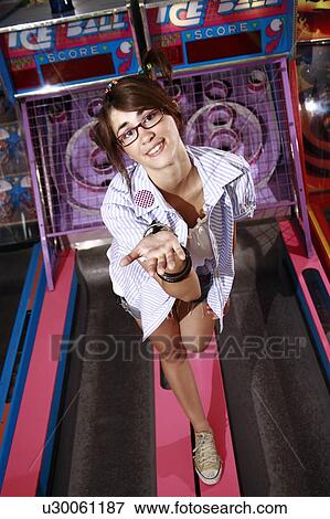 Female teenager on amusement park game with hand out View Large Photo Image Stock Photo - Female teenager on amusement park game with hand out. Fotosearch