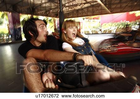 Teenage couple in bumper car in amusement park View Large Photo Image Stock Image - Teenage couple in bumper car in amusement park. Fotosearch