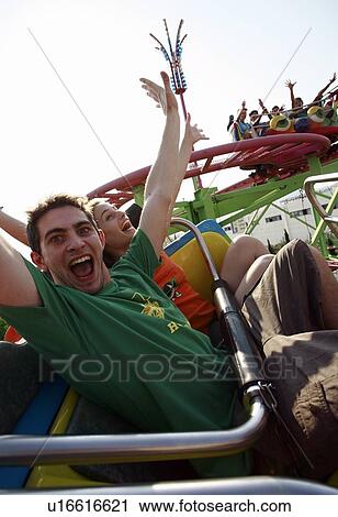Teenage couple on amusement park ride View Large Photo Image Stock Image - Teenage couple on amusement park ride. Fotosearch