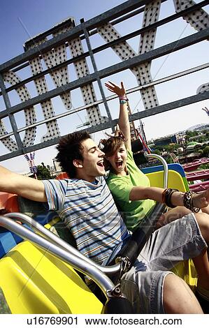 Teenage couple on amusement park ride View Large Photo Image Stock Image - Teenage couple on amusement park ride. Fotosearch