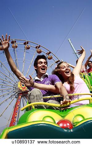 Stock Photo - Teenage couple on amusement park ride. Fotosearch