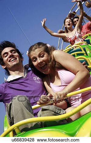 Teenage couple on amusement park ride View Large Photo Image Stock Photo - Teenage couple on amusement park ride. Fotosearch