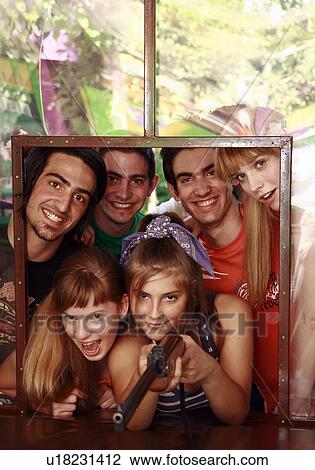 Teenagers at shooting game in amusement park View Large Photo Image Stock Image - Teenagers at shooting game in amusement park. Fotosearch