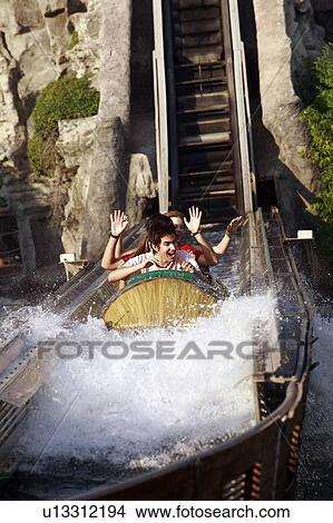 Picture - Teenagers on amusement park ride. Fotosearch