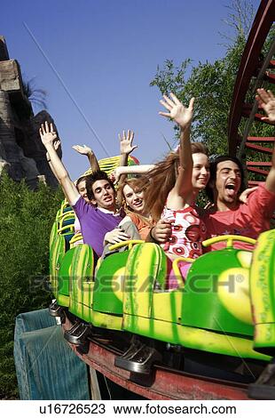 Stock Image - Teenagers on amusement park ride. Fotosearch