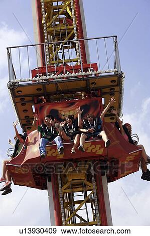 Stock Photo - Teenagers on amusement park ride. Fotosearch