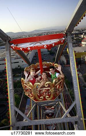 Teenagers on Ferris wheel in amusement park View Large Photo Image Stock Image - Teenagers on Ferris wheel in amusement park. Fotosearch
