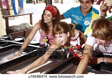 Teenagers playing game in amusement park View Large Photo Image Picture - Teenagers playing game in amusement park. Fotosearch