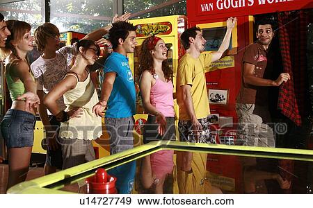 Teenagers waiting on line in arcade View Large Photo Image Stock Photo - Teenagers waiting on line in arcade. Fotosearch