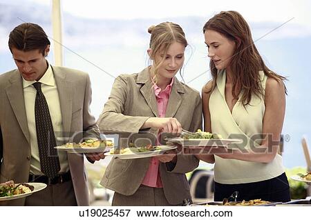 Stock Photo - Business people at lunch buffet. Fotosearch
