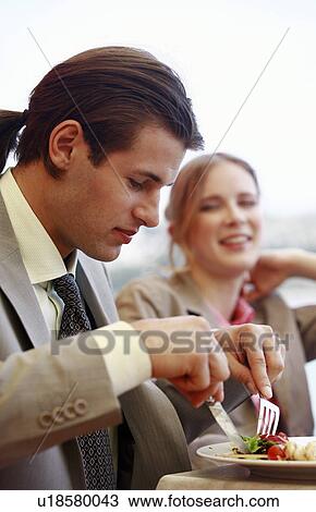 Businessman eating with businesswoman View Large Photo Image Stock Image - Businessman eating with businesswoman. Fotosearch