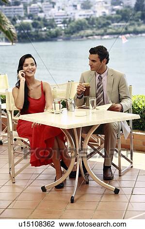 Stock Image - Couple at seaside cafe table. Fotosearch