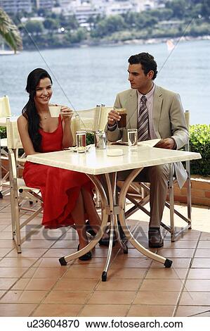 Stock Image - Couple at seaside cafe table. Fotosearch