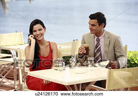 Stock Image - Couple at seaside cafe table. Fotosearch