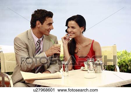 Stock Image - Couple at seaside cafe table. Fotosearch