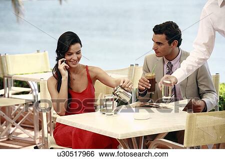 Couple at seaside cafe table View Large Photo Image Stock Photograph - Couple at seaside cafe table. Fotosearch