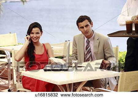 Couple at seaside cafe table with laptop View Large Photo Image Stock Image - Couple at seaside cafe table with laptop. Fotosearch