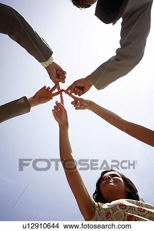 Picture - Group of business people with fingers together. Fotosearch