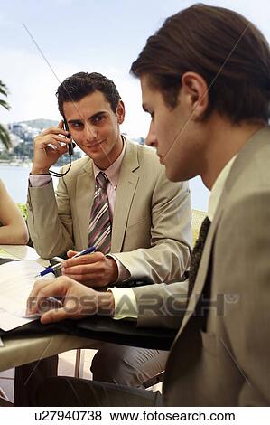 Stock Photo - Two men at a meeting by the sea. Fotosearch