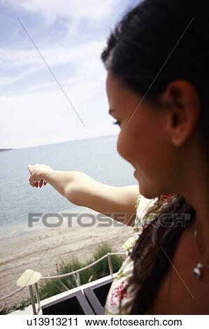 Woman pointing out to sea View Large Photo Image Stock Image - Woman pointing out to sea. Fotosearch