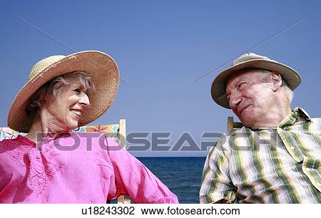 Stock Image - Senior couple on beach. Fotosearch