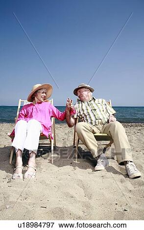 Stock Photo - Senior couple on beach. Fotosearch