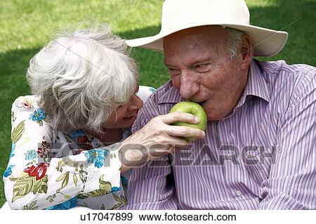 Stock Photo - Senior couple with an apple. Fotosearch