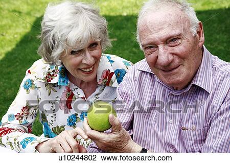 Senior couple with apple View Large Photo Image Stock Image - Senior couple with apple. Fotosearch