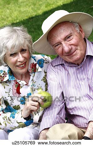 Stock Photo - Senior couple with apple. Fotosearch