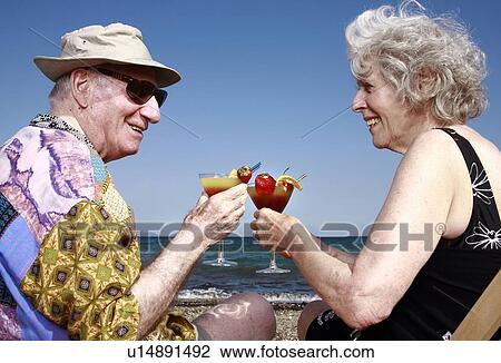 Senior couple with cocktails on beach View Large Photo Image Stock Image - Senior couple with cocktails on beach. Fotosearch