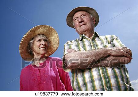 Stock Photo - Senior couple with hats. Fotosearch