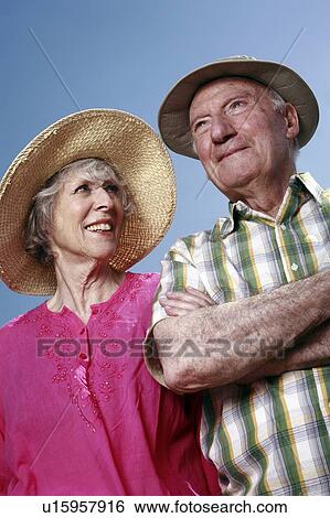 Stock Photograph - Senior couple with hats. Fotosearch
