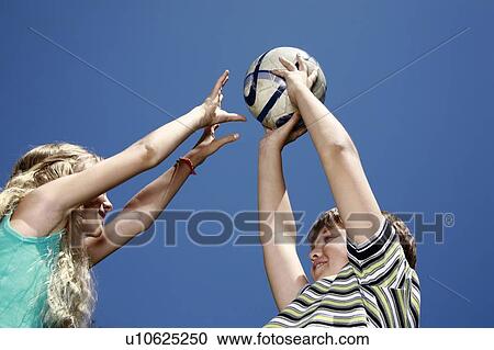 Stock Image - Boy and girl with ball. Fotosearch