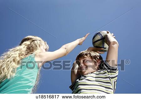 Stock Photo - Boy and girl with ball. Fotosearch