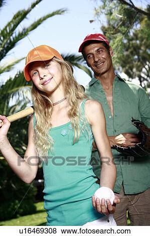 Stock Photo - Father and daughter with baseball outfit. Fotosearch