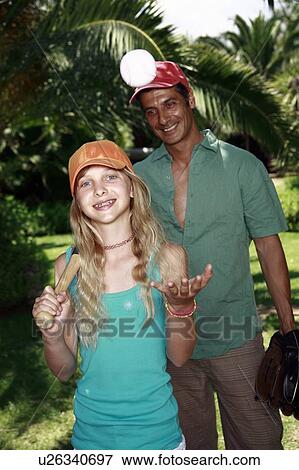 Stock Photo - Father and daughter with baseball outfit. Fotosearch