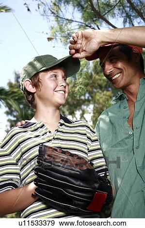 Father and son with baseball caps and glove View Large Photo Image Stock Photo - Father and son with baseball caps and glove. Fotosearch