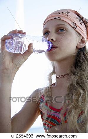 Stock Image - Girl drinking water from a bottle. Fotosearch