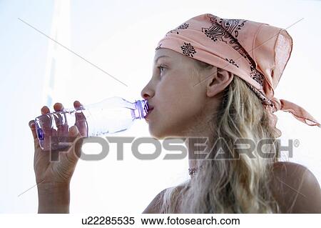 Stock Photography - Girl drinking water from a bottle. Fotosearch