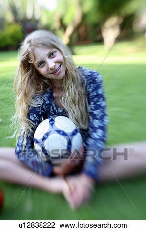 Stock Image - Girl posing with ball. Fotosearch