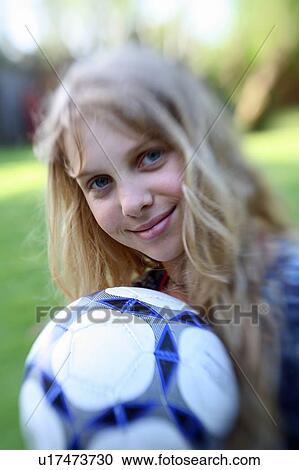 Girl posing with ball View Large Photo Image Stock Image - Girl posing with ball. Fotosearch