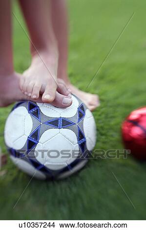 Picture - Two children's feet with balls. Fotosearch