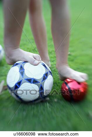 Stock Photo - Two children's legs with balls. Fotosearch