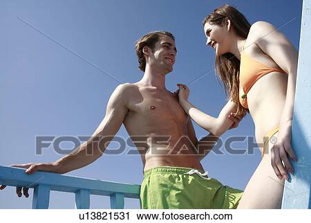 Young adult couple on beach View Large Photo Image Stock Image - Young adult couple on beach. Fotosearch