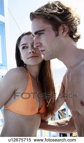 Stock Photography - Young adult couple on beach. Fotosearch