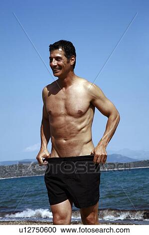 Male mature adult on beach View Large Photo Image Stock Image - Male mature adult on beach. Fotosearch